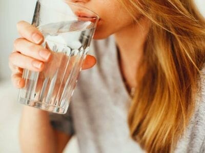 Woman drinking clear water